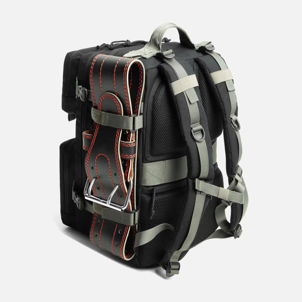 Black backpack with padded straps and attached black weightlifting belt with red stitching on side