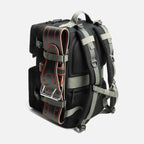 Black backpack with padded straps and attached black weightlifting belt with red stitching on side