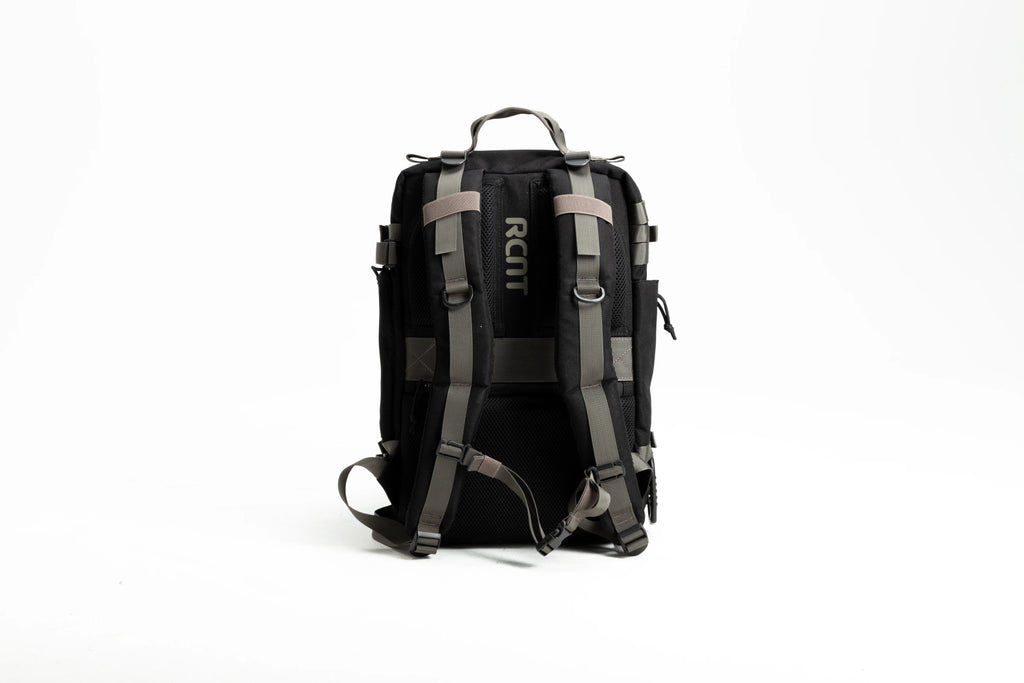 Back view of black and gray RCNT branded backpack with padded straps on white background