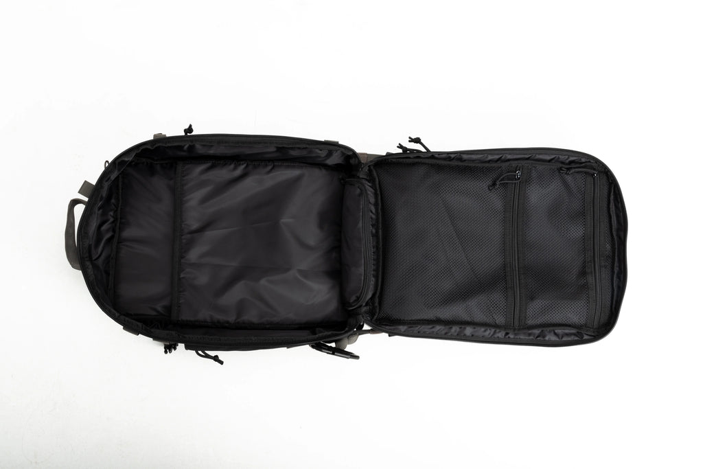 Open black backpack with padded compartments and mesh zippered pockets on white background