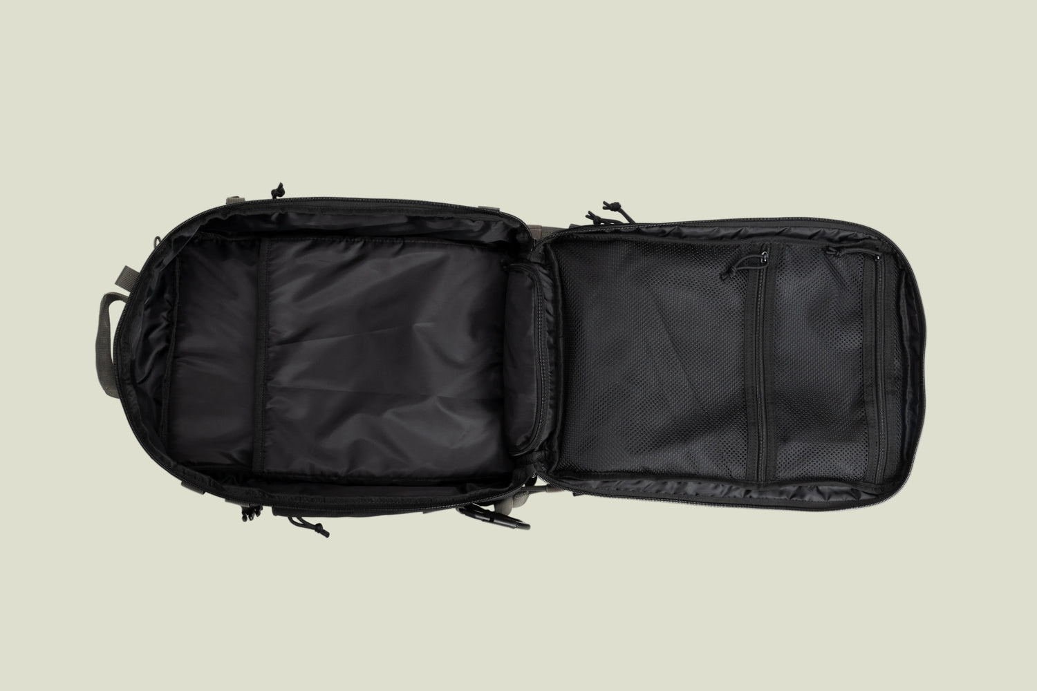 Open black backpack with padded compartments and mesh zippered pockets on white background