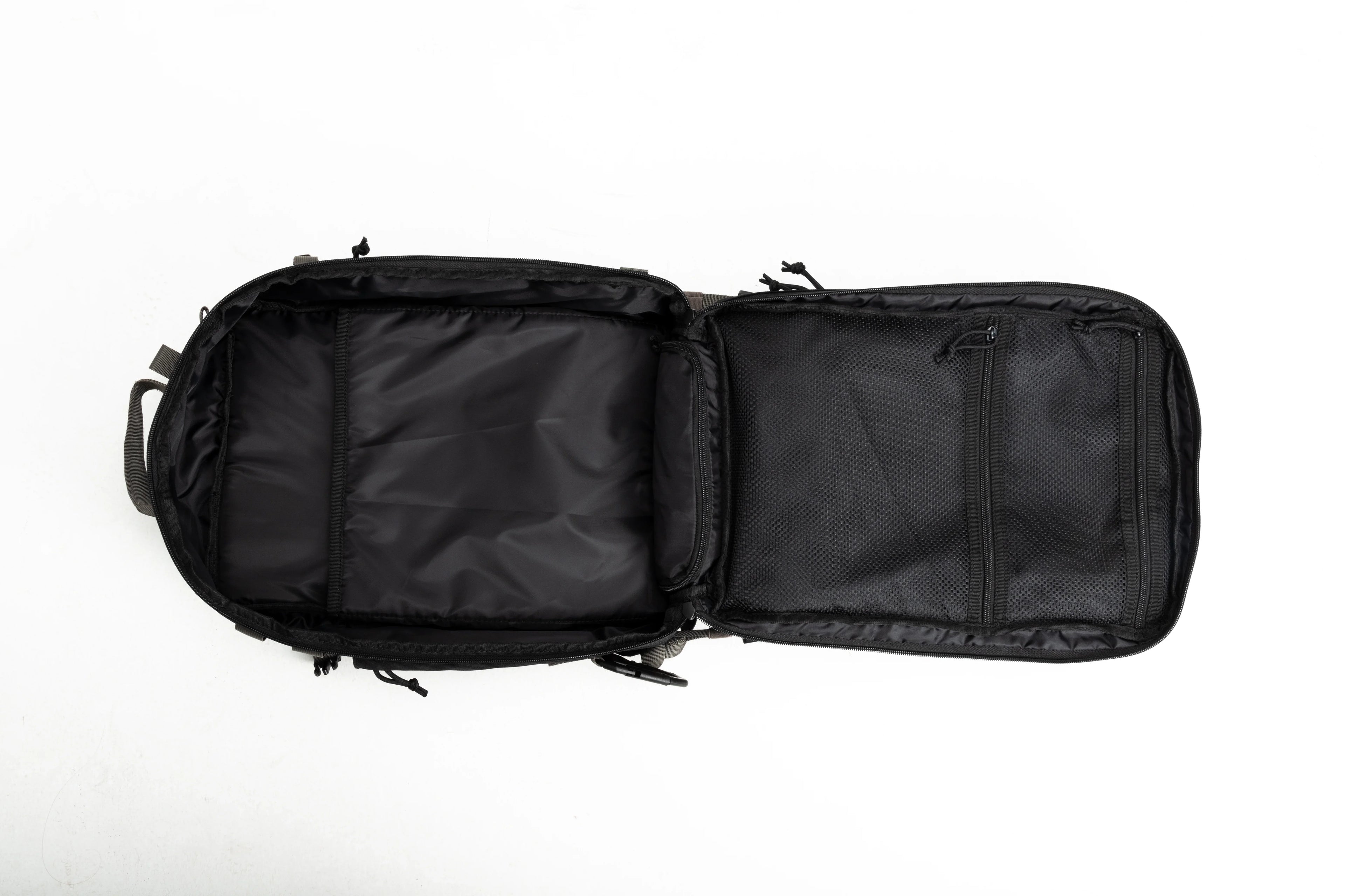 Open black backpack with padded compartments and mesh zippered pockets on white background