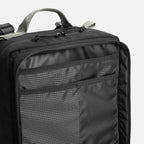 Black backpack with grid-patterned internal organizer pocket and gray handle