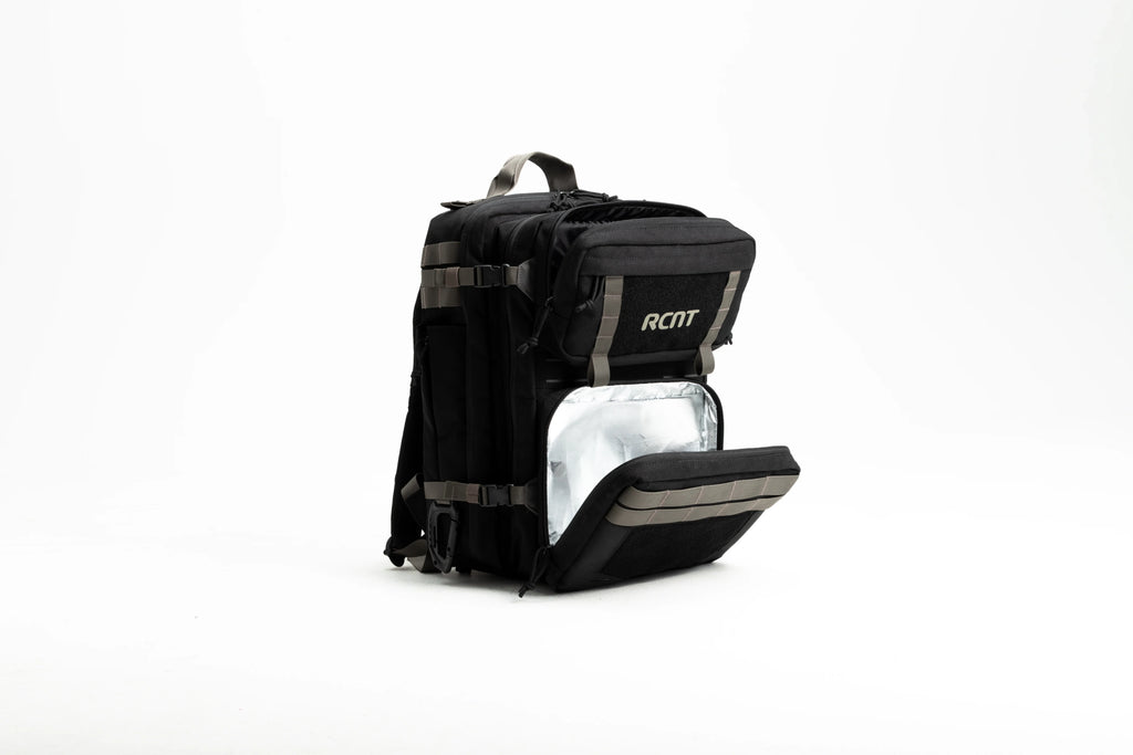 Black backpack with insulated front pocket, tan straps, and RCNT logo on white background