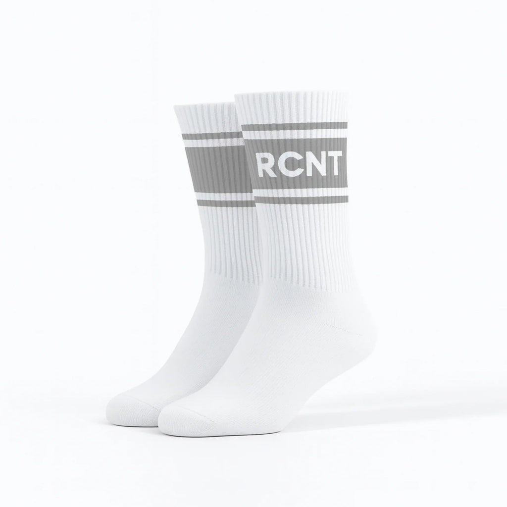 Pair of white retro crew socks with gray stripes and RCNT lettering on a white background