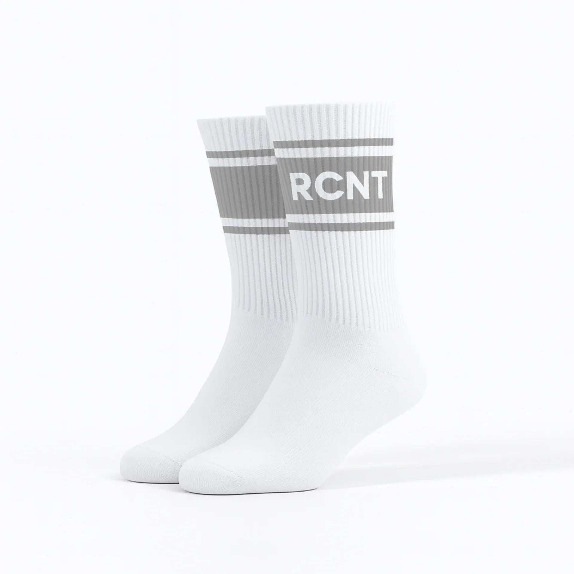 Pair of white retro crew socks with gray stripes and RCNT lettering on a white background