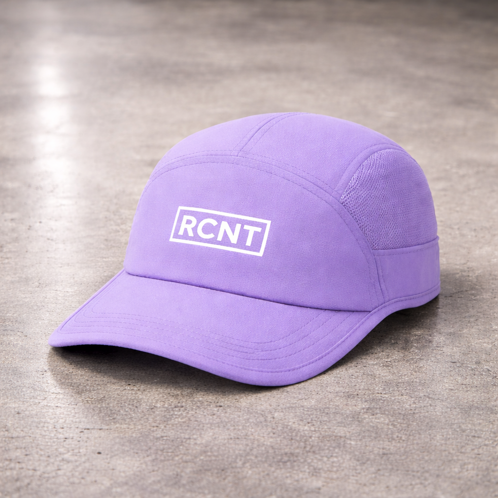 Purple athletic cap with RCNT logo on concrete background