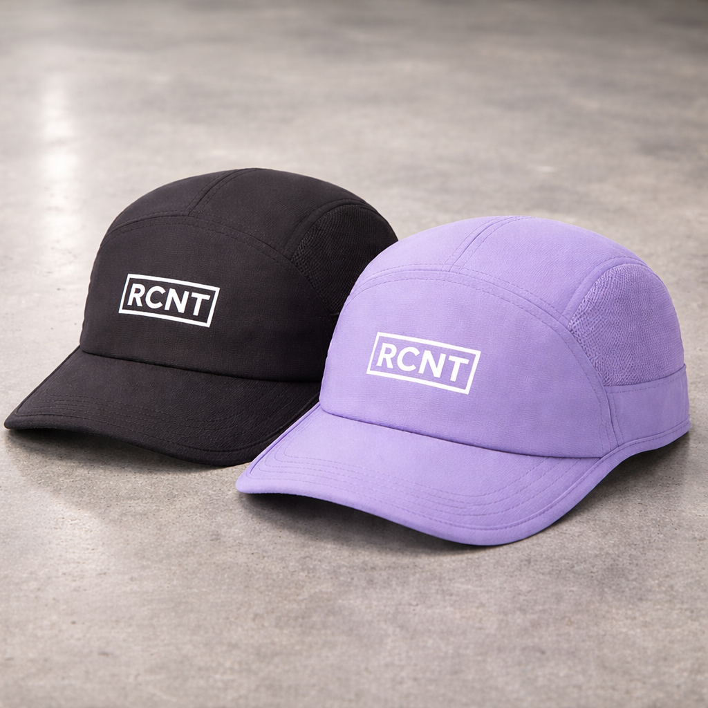 Black and purple caps with 'RCNT' logo on a gray surface