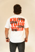 Man wearing white t-shirt with bold red and black 'Know Your Worth' graphic on back
