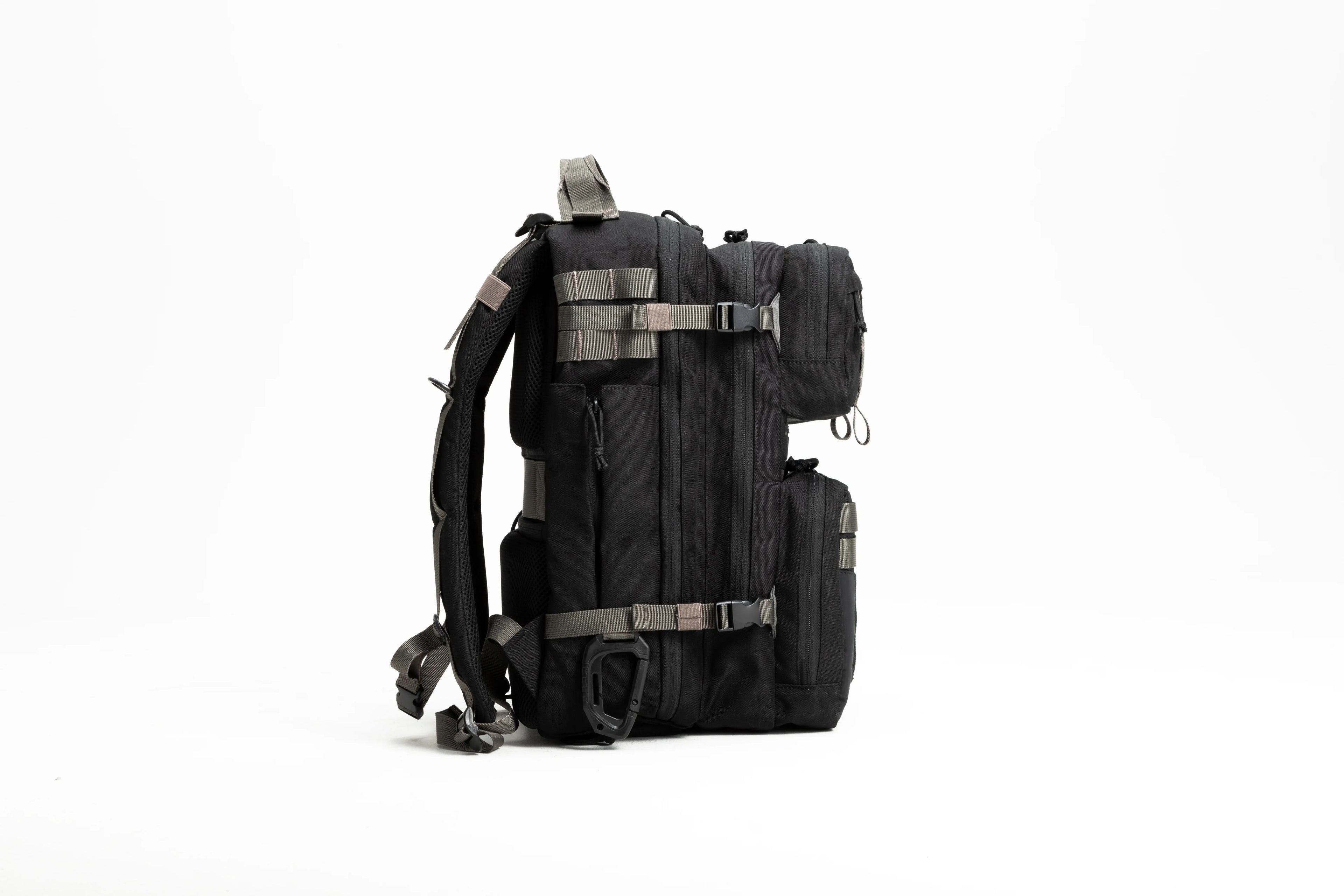Side view of black tactical backpack with multiple compartments and adjustable straps on white background