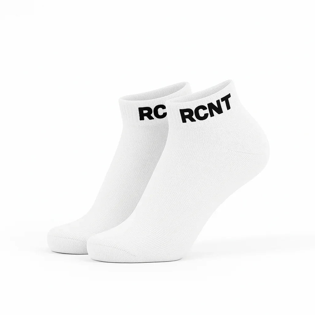 Pair of white ankle socks with black RCNT logo on cuffs on white background