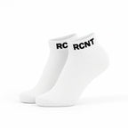 Pair of white ankle socks with black RCNT logo on cuffs on white background