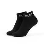 Black ankle socks with white RCNT logo on cuff, isolated on white background
