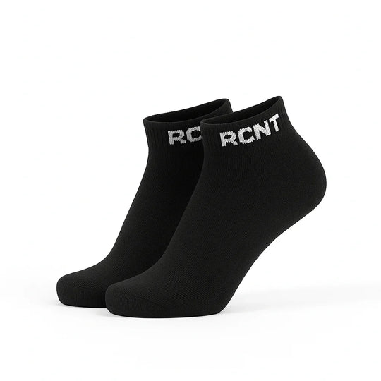 Black ankle socks with white RCNT logo on cuff, isolated on white background